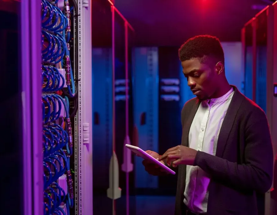 Cyber Security Analyst Using Tablet in Server Room